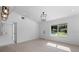 Bright and airy living space featuring sleek tile flooring, modern lighting fixtures, and freshly painted walls at 1740 Lucas Dr, Clearwater, FL 33759
