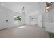 Spacious living area with modern tile floors, accented by stylish light fixtures and access to other rooms at 1740 Lucas Dr, Clearwater, FL 33759