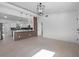 Open-concept living area with tile flooring, leading into a modern kitchen with pendant lighting and a breakfast bar at 1740 Lucas Dr, Clearwater, FL 33759