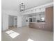 Bright living room with tile floors, open to kitchen featuring modern pendant lighting and stylish breakfast bar at 1740 Lucas Dr, Clearwater, FL 33759