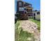 View of the backyard showing the access stairs, and a small storage shed at 19105 Whispering Pines Dr, Indian Shores, FL 33785