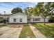 Charming single-story home with a manicured lawn, features a paved driveway and well-maintained landscaping at 1937 N Highland Ave, Clearwater, FL 33755