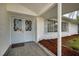 Welcoming front porch with stylish double doors and tiled flooring, complemented by manicured landscaping at 1937 N Highland Ave, Clearwater, FL 33755