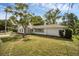 Well-maintained single-story home with a manicured lawn and mature landscaping, accented by a paved driveway at 1937 N Highland Ave, Clearwater, FL 33755