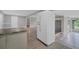 Open-concept kitchen showcasing stainless steel refrigerator, granite countertops, and wood-look flooring at 1937 N Highland Ave, Clearwater, FL 33755
