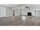 Living room with updated flooring and a painted brick fireplace, neutral paint, and abundant natural light at 1937 N Highland Ave, Clearwater, FL 33755