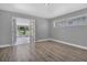 Bright living room featuring wood-look flooring and glass doors leading to the sunroom at 1937 N Highland Ave, Clearwater, FL 33755