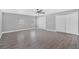 Spacious primary bedroom with modern ceiling fan, and durable, wood-look flooring at 1937 N Highland Ave, Clearwater, FL 33755