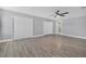 Main bedroom with ensuite bathroom, updated flooring, ceiling fan, and abundant closet space at 1937 N Highland Ave, Clearwater, FL 33755