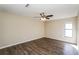Comfortable bedroom with neutral walls, stylish floors, a ceiling fan, and a window for natural light at 3460 Tomahawk Ave, Spring Hill, FL 34606
