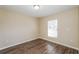 Bedroom features neutral paint, hardwood floors, and a window providing ample natural light at 3460 Tomahawk Ave, Spring Hill, FL 34606