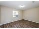 Bright bedroom with hardwood floors, neutral paint, and a window to provide natural light at 3460 Tomahawk Ave, Spring Hill, FL 34606