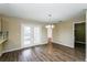 Cozy dining area with stylish lighting, wood-look flooring, and direct access to the outdoor living space at 3460 Tomahawk Ave, Spring Hill, FL 34606