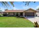 Charming home featuring a well-manicured lawn, complemented by tasteful landscaping, and a two car garage at 3460 Tomahawk Ave, Spring Hill, FL 34606