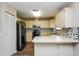 Functional kitchen featuring modern appliances, tile backsplash, and ample counter space for meal preparation at 3460 Tomahawk Ave, Spring Hill, FL 34606
