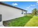 Side yard featuring grass lawn, an exterior patio, and view of the water at 27 Bunker Ct, Rotonda West, FL 33947