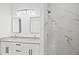 Bright bathroom featuring double sinks, and a marble-look tiled shower at 27 Bunker Ct, Rotonda West, FL 33947