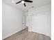 Bright bedroom featuring a ceiling fan, closet, and a door, with light wood flooring at 27 Bunker Ct, Rotonda West, FL 33947