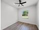 Clean, bright bedroom with a ceiling fan and large window providing a view of the front yard at 27 Bunker Ct, Rotonda West, FL 33947