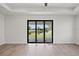 Bright living room featuring wood flooring and a large set of folding glass doors at 27 Bunker Ct, Rotonda West, FL 33947