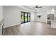 Bright open-concept living room boasts seamless access to the outdoors with an oversized sliding glass door at 27 Bunker Ct, Rotonda West, FL 33947