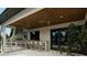 Outdoor kitchen on the covered patio with a built-in grill, seating and a ceiling fan at 4013 W Inman Ave, Tampa, FL 33609