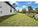 Back yard view, highlighting the lush lawn and landscaping at 9739 Loretto St, Spring Hill, FL 34608