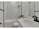 Modern bathroom featuring white tile, a sleek vanity, and black fixtures for a contemporary design at 9739 Loretto St, Spring Hill, FL 34608