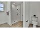 Bright bathroom featuring a walk-in shower with white tile and black fixtures plus a toilet with leafy decor at 9739 Loretto St, Spring Hill, FL 34608