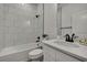 Modern bathroom featuring white tile, a sleek vanity, and black fixtures for a contemporary design at 9739 Loretto St, Spring Hill, FL 34608