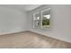 Bright bedroom with light-colored wood floors, white walls, and windows overlooking the outdoors at 9739 Loretto St, Spring Hill, FL 34608