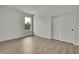 Bright bedroom showcasing a large window and closet with vinyl floors at 9739 Loretto St, Spring Hill, FL 34608