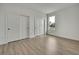 Bright bedroom showcasing a closet and large window with vinyl floors at 9739 Loretto St, Spring Hill, FL 34608