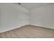 A well-lit bedroom with light-colored wood floors and a spacious closet with sliding doors at 9739 Loretto St, Spring Hill, FL 34608
