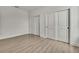 A spacious bedroom with light-colored wood floors and white closet doors for ample storage at 9739 Loretto St, Spring Hill, FL 34608