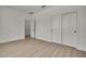 Bright bedroom with light-colored wood floors and a spacious closet with double doors at 9739 Loretto St, Spring Hill, FL 34608