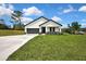 Inviting front exterior with well-kept lawn and modern farmhouse design at 9739 Loretto St, Spring Hill, FL 34608