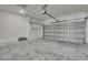 Spacious garage with concrete floors, an automatic door opener, and white walls for a clean look at 9739 Loretto St, Spring Hill, FL 34608