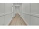 Bright hallway features hardwood floors, white walls with decorative trim, and leads to other rooms at 9739 Loretto St, Spring Hill, FL 34608