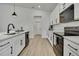 Bright kitchen featuring white cabinets, sleek black hardware, and modern appliances at 9739 Loretto St, Spring Hill, FL 34608
