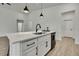 Kitchen island featuring a stainless steel sink and black faucet at 9739 Loretto St, Spring Hill, FL 34608