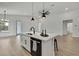 Open concept kitchen island with stainless steel sink, black faucet, and modern design at 9739 Loretto St, Spring Hill, FL 34608