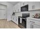 Modern kitchen with white cabinets, black appliances, and stylish countertops at 9739 Loretto St, Spring Hill, FL 34608