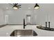 Kitchen island with a sink, black faucet, and modern lighting at 9739 Loretto St, Spring Hill, FL 34608
