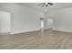 Spacious living room features hardwood floors and white walls leading to other rooms in the home at 9739 Loretto St, Spring Hill, FL 34608