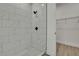 Close up of luxurious tiled walk-in shower with black fixtures and tiled floor at 9739 Loretto St, Spring Hill, FL 34608