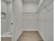 Walk-in closet with custom shelving and vinyl floors at 9739 Loretto St, Spring Hill, FL 34608