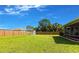 Fenced backyard with green grass and a shed at 1049 Presque Isle Dr, Port Charlotte, FL 33952