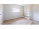 Neutral bedroom featuring wood-look flooring, a large window, and a built-in white bookshelf at 1049 Presque Isle Dr, Port Charlotte, FL 33952