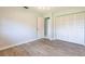 Cozy bedroom with wood-look tile flooring and large bi-fold closet at 1049 Presque Isle Dr, Port Charlotte, FL 33952